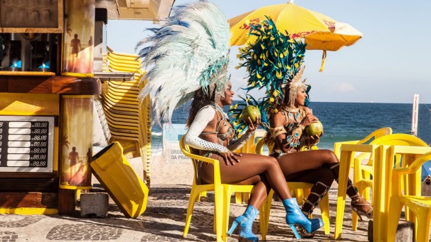 Samba dancers taking a break, Ipanema Beach, Rio De Janeiro, Brazil.