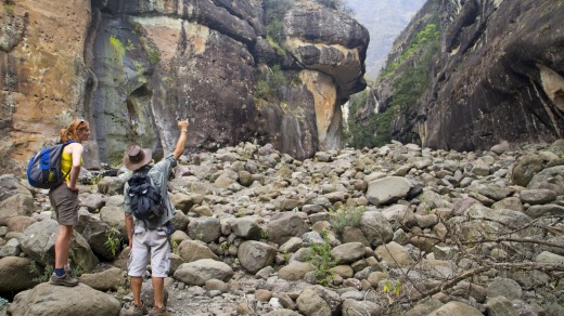 Hikers inside the Amphitheatre in South Africa's Drakensberg Mountains.