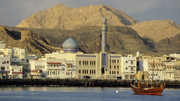 An Arab dhow, Shia mosque and traditional waterfront architecture in Muscat, Oman.