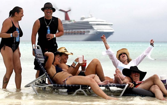 Fans rest in the water at Half Moon Cay, the Bahamas, christened 'Red Neck Paradise' by Kid Rock for the cruise.