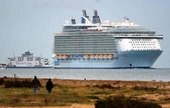 The world's largest cruise ship, Oasis of the Seas, dwarfs the Isle of Wight ferry as she enters The Solent, near ...