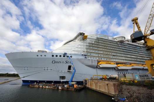 The world's largest cruise ship, Oasis of the Seas, dwarfs the Isle of Wight ferry as she enters The Solent, near ...