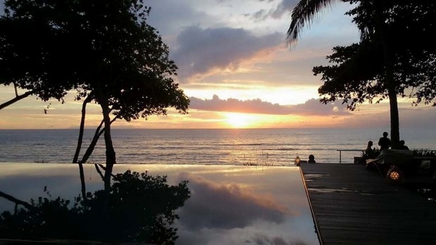 LOMBOK, BALI. The beach in front of Jeeva Klui Resort looks west across the Lombok Strait to Bali, and it's a sunset ...