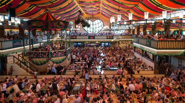 Visitors enjoy the brand-new festival beer tent 'Marstall' during the opening day of the 2014 Oktoberfest.