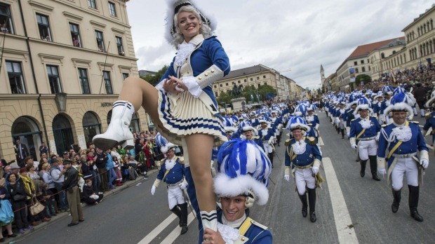 People dressed in traditional clothes take part in the Oktoberfest parade in Munich.