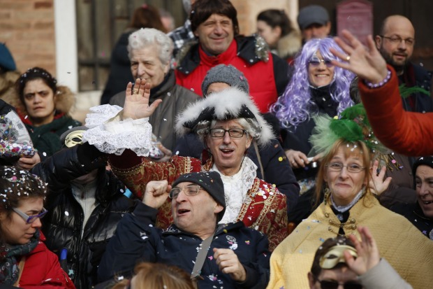 Spectators enjoy the water parade, part of the Venice Carnival, in Venice, Italy. The Venice carnival in the historical ...