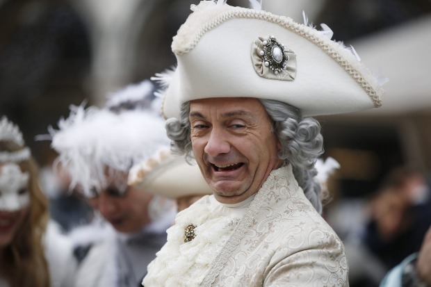 A man impersonating Giacomo Casanova smiles in St. Marks' Square, during the Carnival, in Venice, Italy.