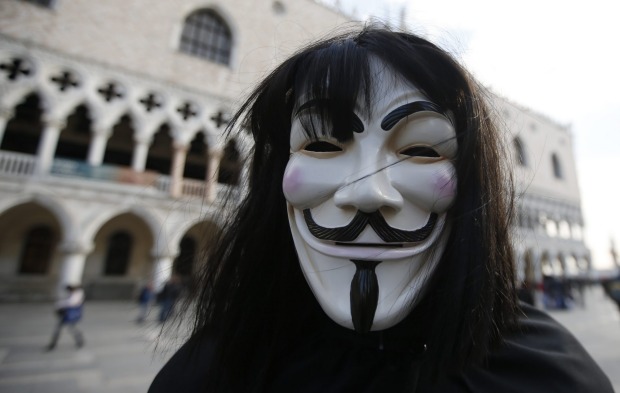 A man wearing an Anonymous mask is seen prior to the Carnival Grand Opening show, in Venice, Italy.