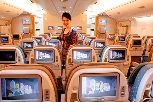 Singapore Airlines flight attendant on A380 economy class.