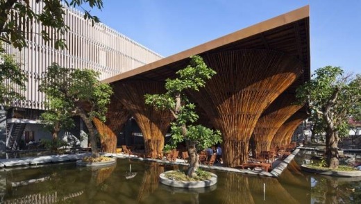 The bamboo columns of the waterside cafe in the Kon Tum Indochine Hotel are inspired by the form of the Vietnamese ...
