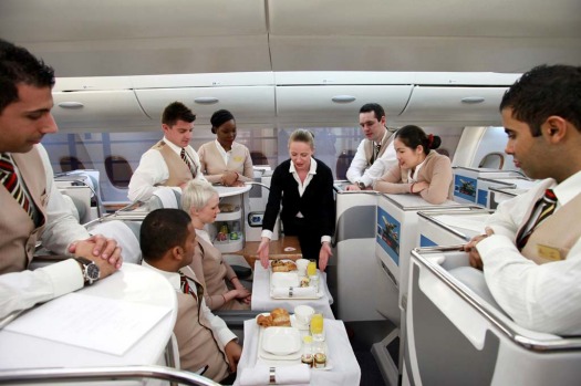 Patricia Walsh, an instructor with Emirates Airline, centre, demonstrates in flight service for business class ...