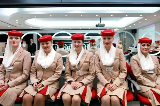 Flight attendant students for Emirates pose in the image and uniform classroom at the Emirates Aviation College in Dubai.