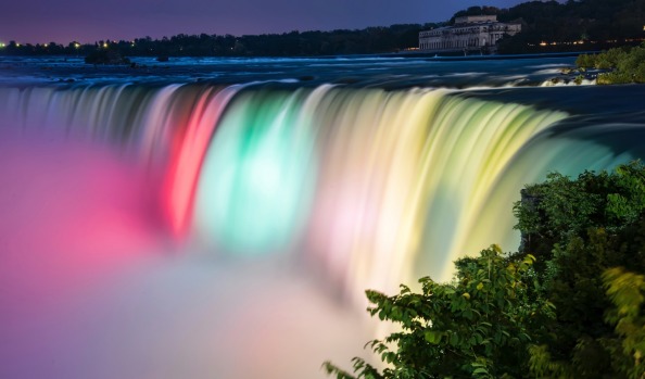 Niagara falls lit by colorful lights of many colors