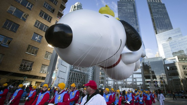 A giant Snoopy balloon is marched through Columbus Circle during the Annual Macy's Thanksgiving Day Parade.
