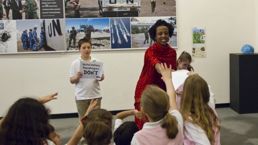 A UN Headquarters Tour Guide quizzes school children during their visit to the General Assembly building.