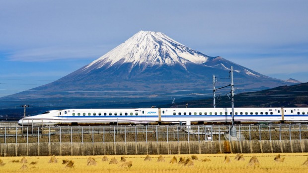 A bullet train passes below Mt Fuji in Japan.