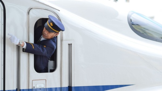 Precision: A guard giving hand signals on a bullet train.