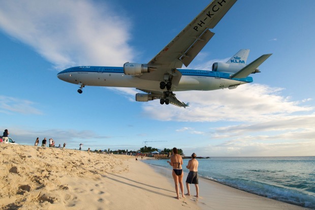 A planespotter's dream: Aircraft land at Princess Juliana International Airport just metres above the heads of ...