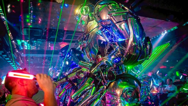 Customers watch on as a large scale robot performs during a show at The Robot Restaurant in Tokyo, Japan.