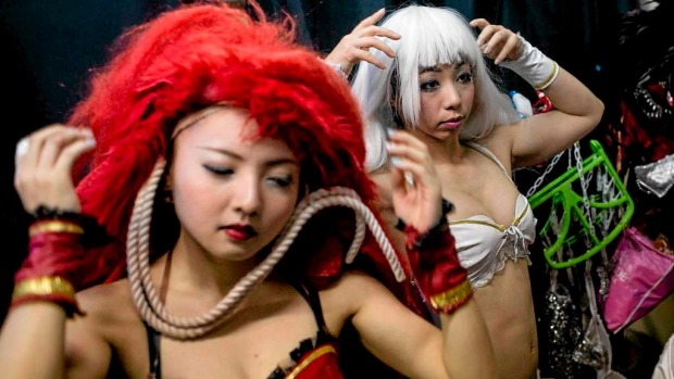 Performers change into their costumes backstage prior to the start of a show at The Robot Restaurant in Tokyo, Japan.