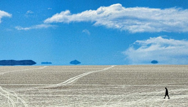 A tourist is seen walking along the salt flats at the Uyuni salt flats, Bolivia.