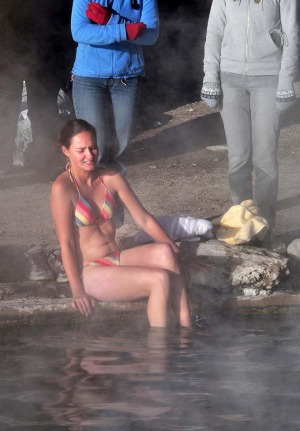 A tourist enters the water at a hot spring near the small village of Agua Brava.