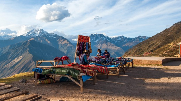Peruvian women in national clothes sell the products of their weaving in the tourist spot of Sacred Valley on the road ...