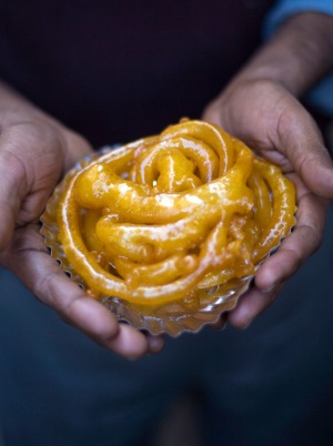A man holds jalebis at the Old & Famous Jalebi Wala.