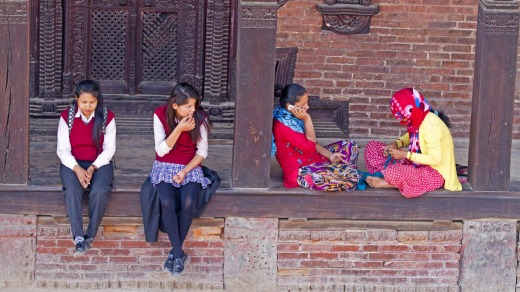 Local women and school girls hanging out on the steps of a temple in Bhaktapur's old town.