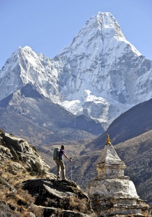 Woman trekker with Ama Dablam in the Khumbu Region of Nepal.