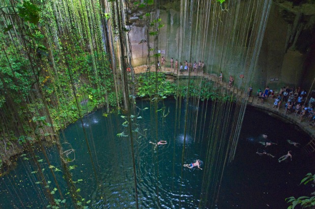 Tourists swimming in Ikil Cenote in Yucatan, Mexico.