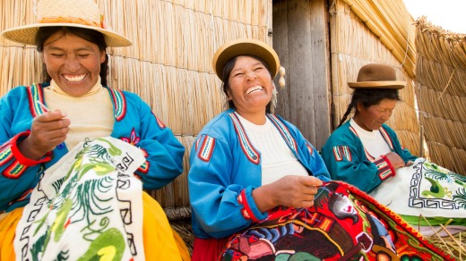 Native Uru women doing embroidery on the Floating islands of Lake Titicaca, Puno, Peru.