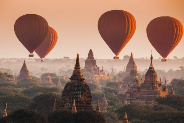 Hot air balloon over plain of Bagan in misty morning, Myanmar.