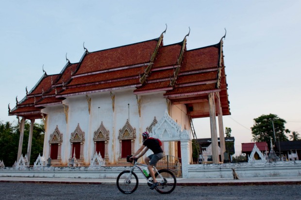 Passing a temple in a small local village outside Surat Thani.