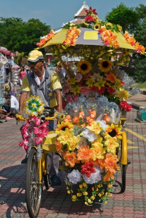 A garishly decorated rickshaw in Town Square, Malacca.