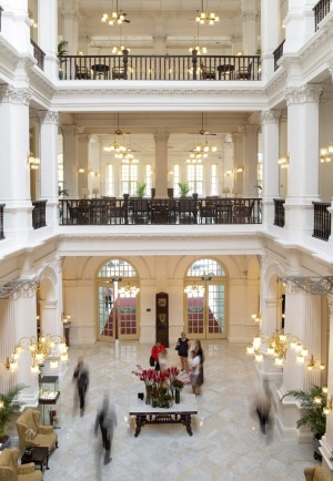 The colonial style lobby from the second floor walkway of the Raffles Hotel.