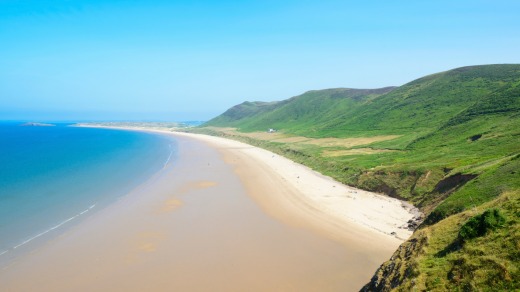 Rhossili Bay Beach, Gower Peninsula, Wales. A beautiful expanse of pristine sand often voted one of the world's best ...