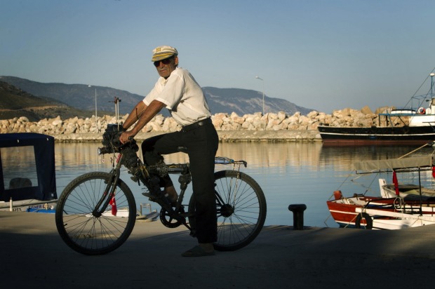 A local man shows off his self-modified bicycle, now with a toolset attached to the steering shaft, in the small coastal ...