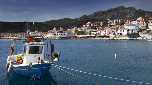 A Greek caique (fishing boat) is  moored in Kokkari bay, on the Greek island of Samos.