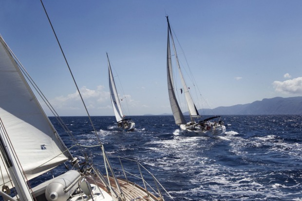 Yachts racing in the Agean Sea between Turkey and Greece, with Greece's Dodecanese islands in the background.