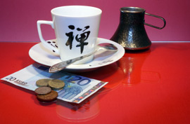 tea cup on a table with euros and coins