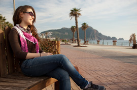 woman bench beach smile travel