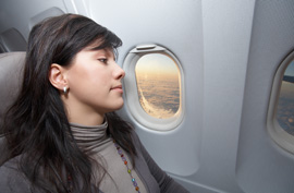 airplane window seat woman flight air travel vacation trip