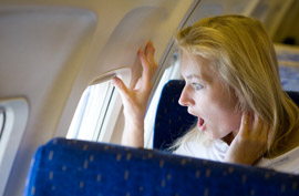 airplane woman shocked surprised open mouth