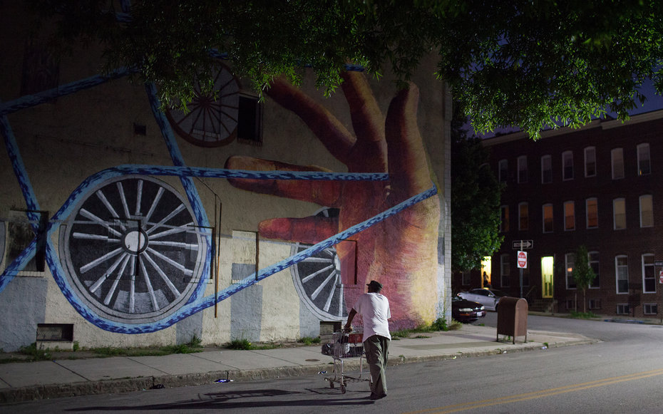 BALTIMORE, MD - MAY 26, 2015: A man collecting cans for recycling walks across Barclay Street in Station North Arts District, Baltimore, Md. (Photo by Lance Rosenfield for The Washington Post via )