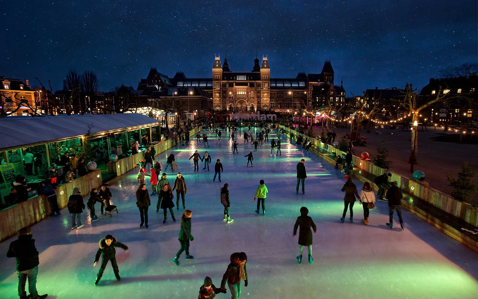 [UNVERIFIED CONTENT] Crowded ice skating rink with starry sky at night, Museumplein Amsterdam. In front of the Rijksmuseum.