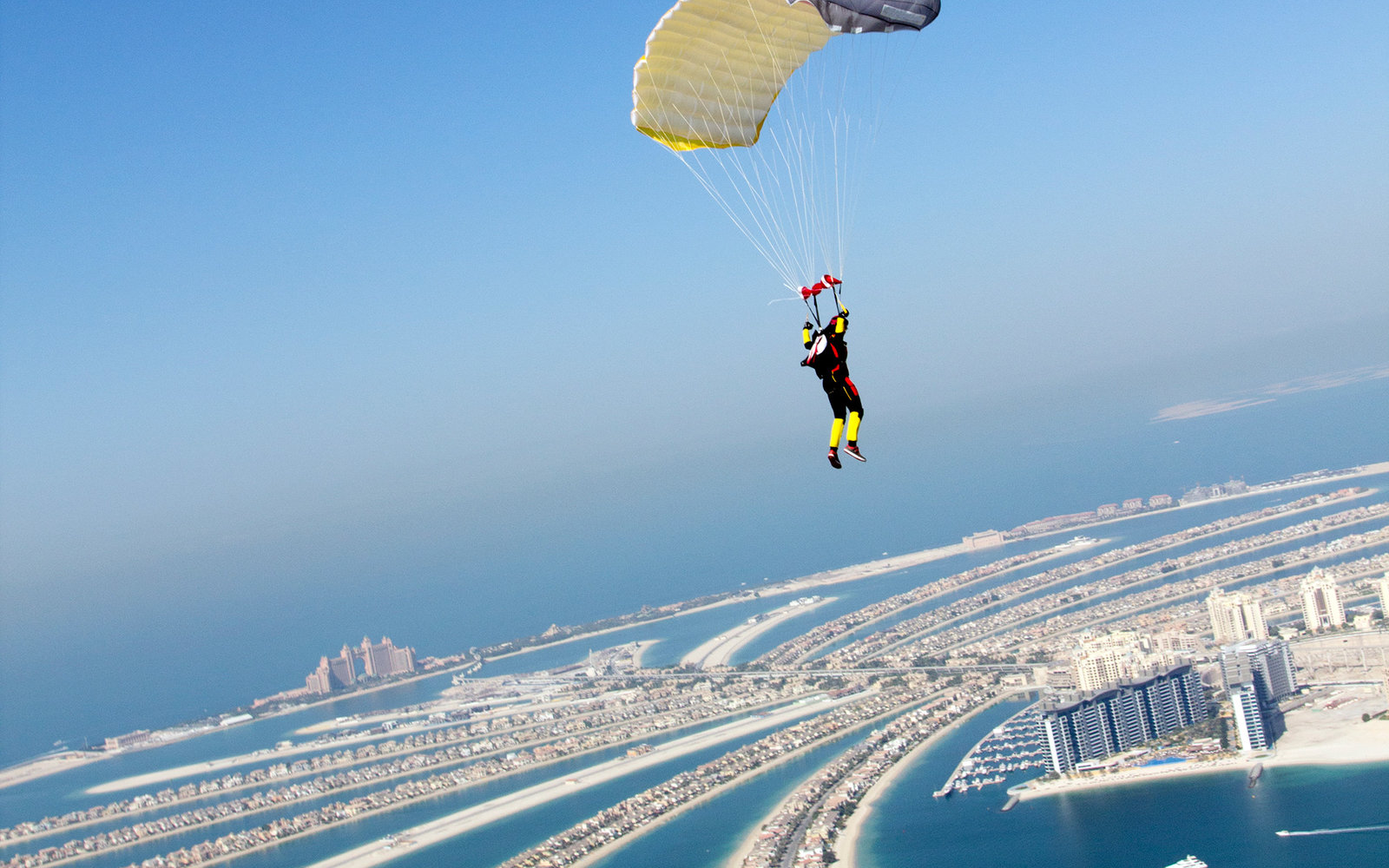 Jumper under canopy flying over the Dubai Palm