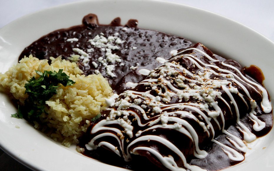Chicken enchiladas in mole served at Yxta Cocina Mexicana in downtown Los Angeles on April 20, 2011.  (Photo by Anne Cusack/Los Angeles Times via )
