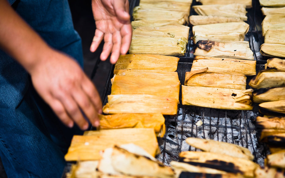 Mid section view of a man roasting tamales on barbecue grill, Zacatecas State, Mexico